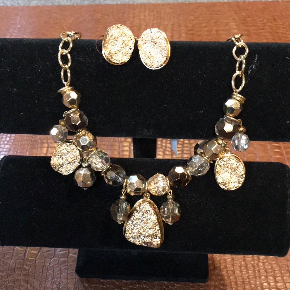 Gold tone necklace with matching earrings.